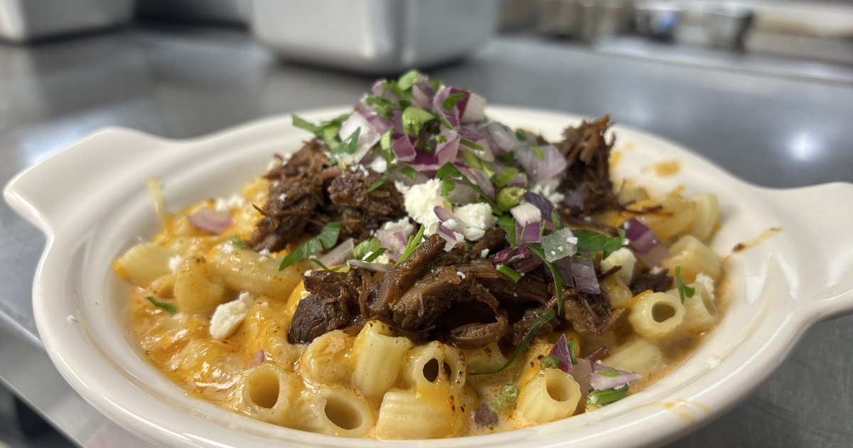Birria Mac & Cheese — creamy three-cheese mac loaded with slow-braised beef birria, consomé drizzle, red onion, cilantro and queso fresco, today's $16 Chef's Choice at Guat-A-Taco in Manning, SC