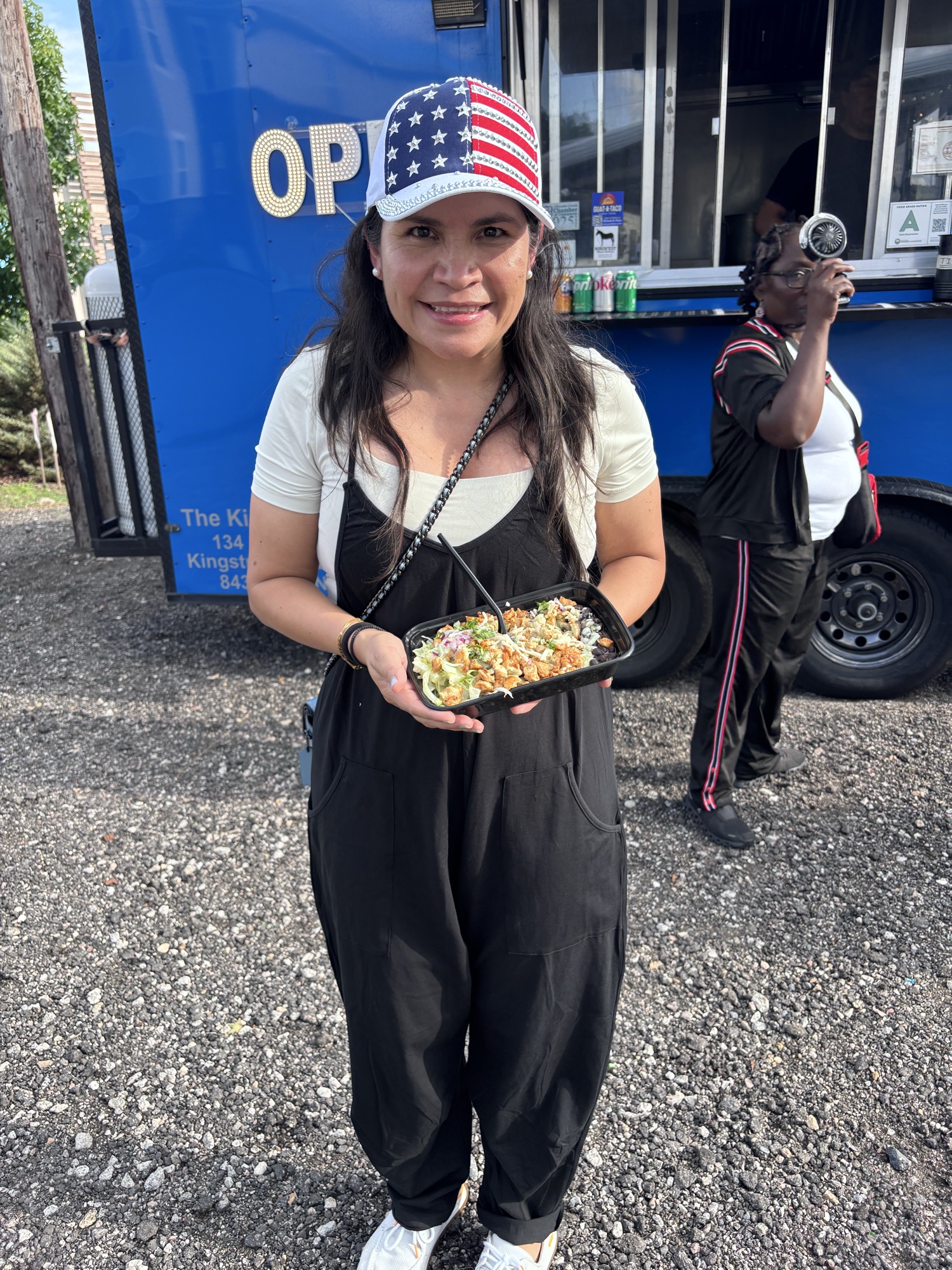 Guat-A-Taco food truck owner holding the Boxcar Burger